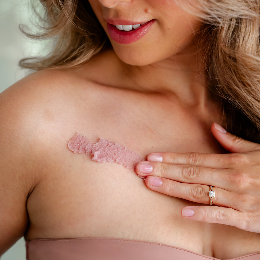 woman applying Mazu body scrub natural exfoliating body scrub for smooth skin