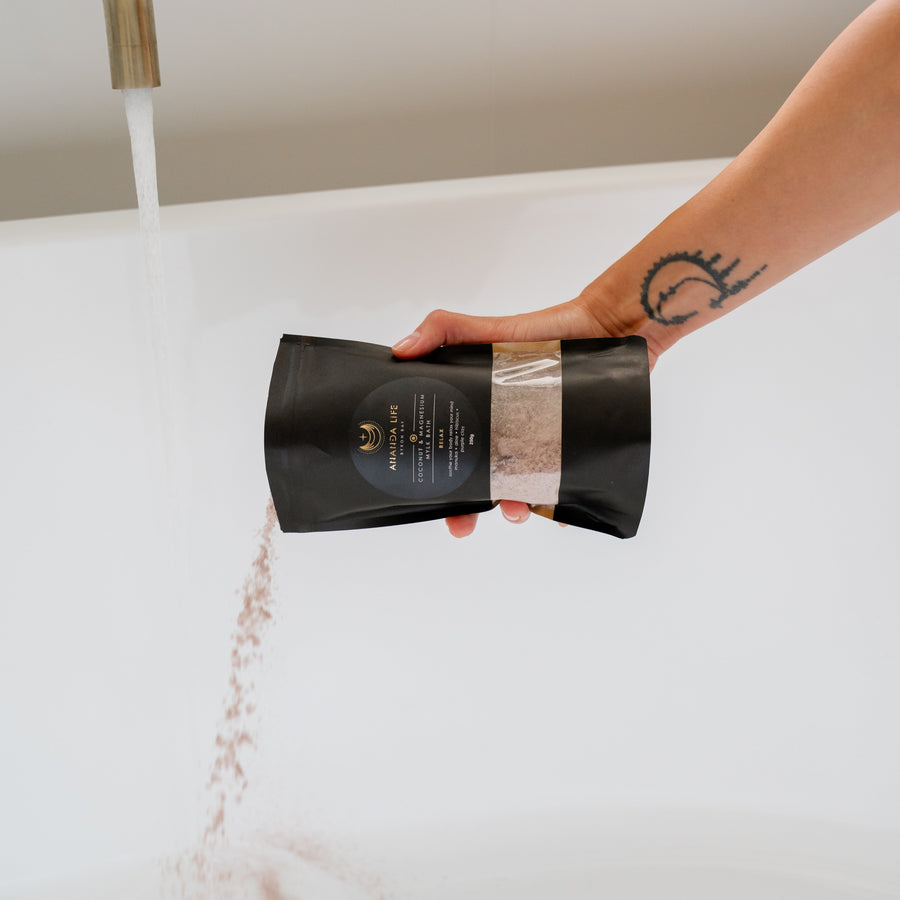 Relax coconut magnesium bath soak pouring mineral bath salts into bath